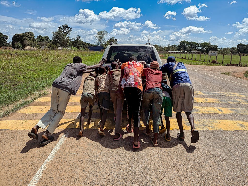 pushing a car on a rural road