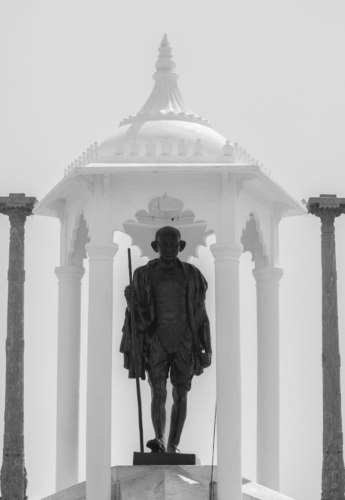 Black and white photo of Mahatma Gandhi statue in Puducherry, India. Captivating and historic landmark view.