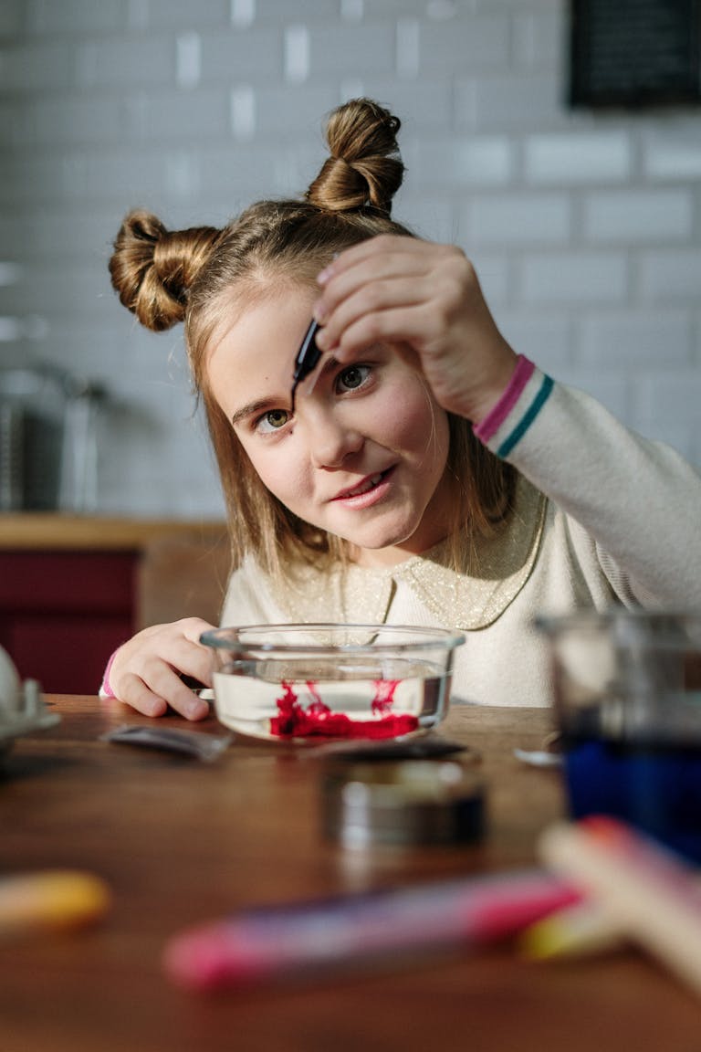 young girl in kitchen crafting easter decorations with concentration and creativity. 3971299 scaled